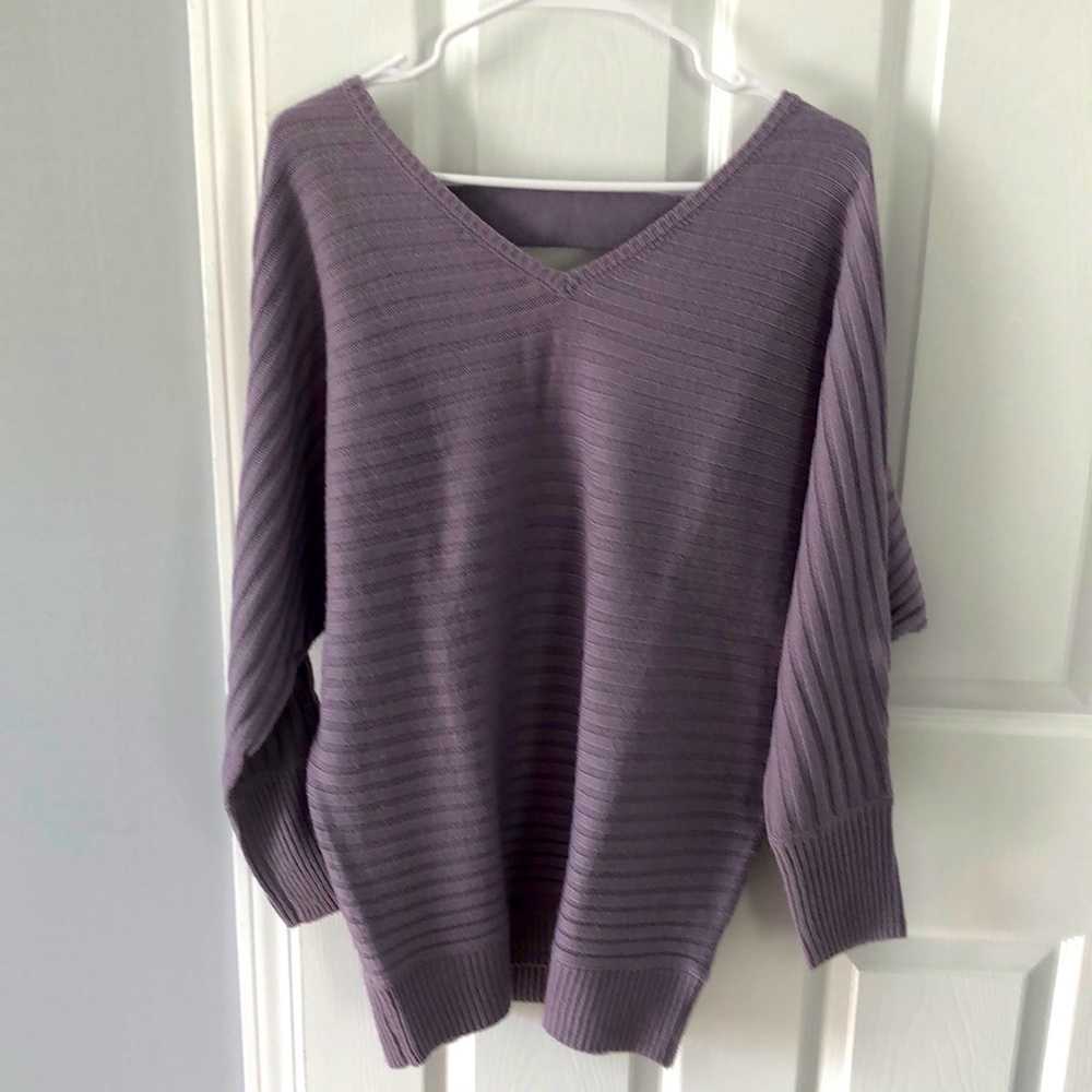 Periwinkle knit V-neck, baggy at top, cinched waist. Marked XS but fit up to M